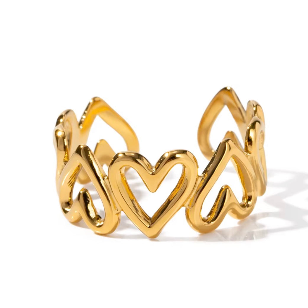 Gold ring with heart design on a white background