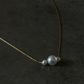 Pearl necklace on a dark textured surface